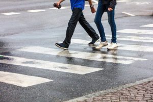 pedestrians walking across street